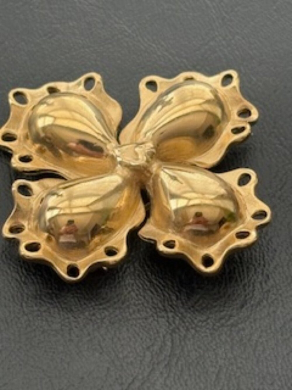 Beautiful polished gold tone metal brooch